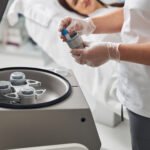 female doctor hands putting test tube into metal c 2025 03 06 01 21 04 utc